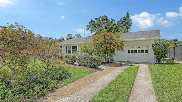 2088 Grove St, Sarasota, FL 34239 - view of front of property with concrete driveway, a garage, stucco siding, and a front lawn