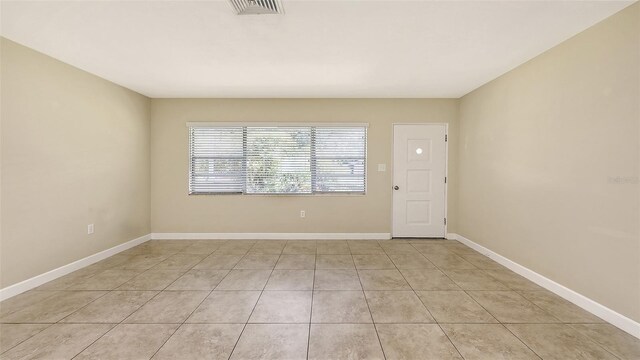 2088 Grove St, Sarasota, FL 34239 - empty room featuring light tile patterned flooring and baseboards