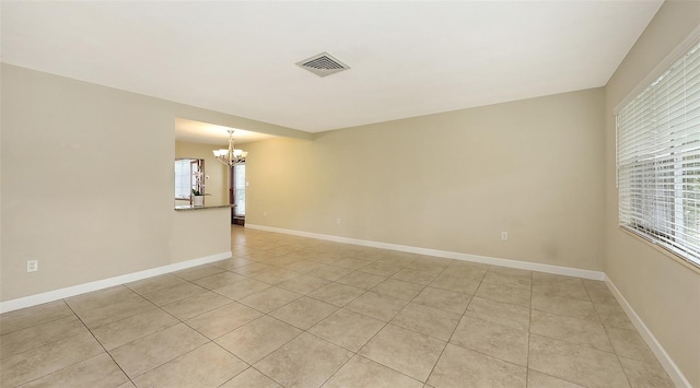 2088 Grove St, Sarasota, FL 34239 - spare room featuring a chandelier and light tile patterned floors