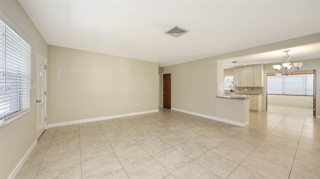 2088 Grove St, Sarasota, FL 34239 - empty room with a chandelier and light tile patterned floors