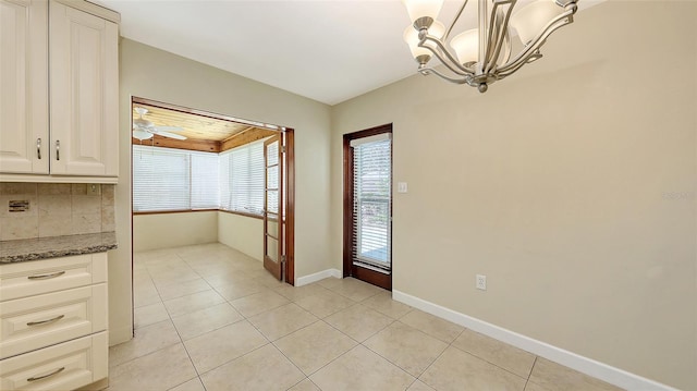 2088 Grove St, Sarasota, FL 34239 - unfurnished dining area featuring a chandelier and light tile patterned floors