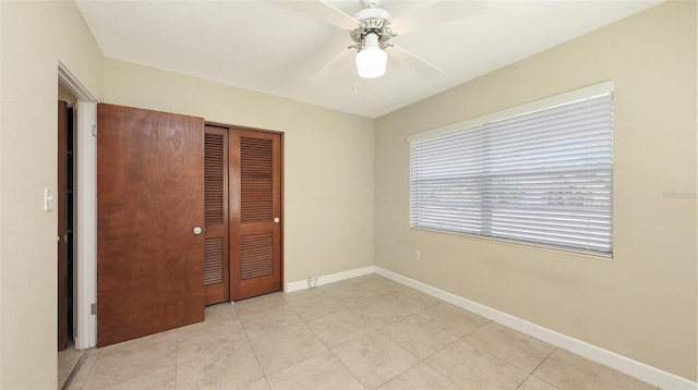 2088 Grove St, Sarasota, FL 34239 - unfurnished bedroom with a closet, light tile patterned floors, and ceiling fan