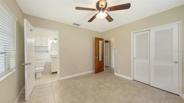 2088 Grove St, Sarasota, FL 34239 - unfurnished bedroom with light tile patterned flooring, a closet, ensuite bath, and ceiling fan