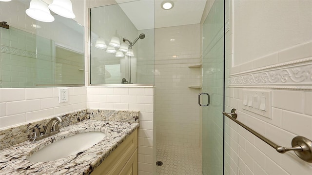 2088 Grove St, Sarasota, FL 34239 - bathroom with tile walls, a stall shower, and vanity