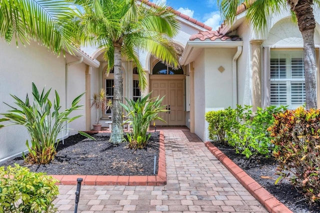 6312 41st Ct E, Sarasota, FL 34243 - property entrance featuring stucco siding and a tiled roof