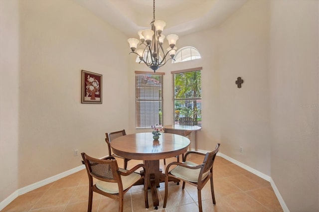 6312 41st Ct E, Sarasota, FL 34243 - dining area with light tile patterned floors, a chandelier, and a tray ceiling