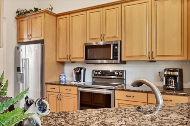 6312 41st Ct E, Sarasota, FL 34243 - kitchen featuring appliances with stainless steel finishes and dark stone countertops