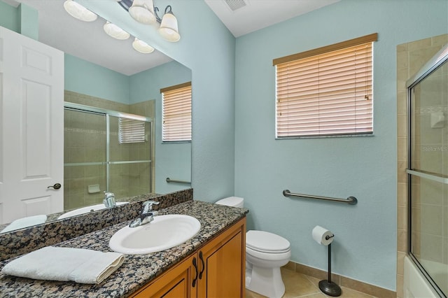 6312 41st Ct E, Sarasota, FL 34243 - full bathroom with vanity, tile patterned flooring, and tiled shower / bath combo