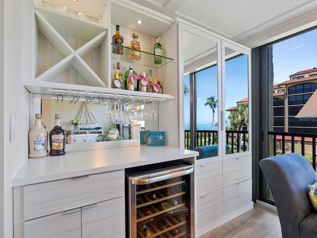 8710 Midnight Pass Rd Unit 205, Sarasota, FL 34242 - indoor dry bar featuring beverage cooler and light wood finished floors