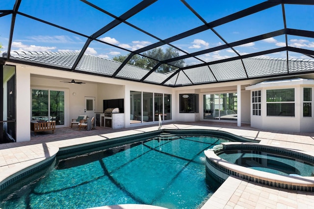 7211 Marston Ct, University Park, FL 34201 - view of swimming pool featuring an outdoor kitchen, a patio, glass enclosure, a pool with connected hot tub, and a ceiling fan