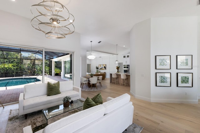 7211 Marston Ct, University Park, FL 34201 - living area featuring light wood-type flooring and a chandelier