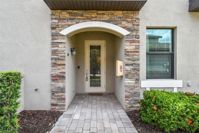 5916 Wake Forest Run Unit 101, Bradenton, FL 34211 - view of exterior entry featuring stone siding and stucco siding