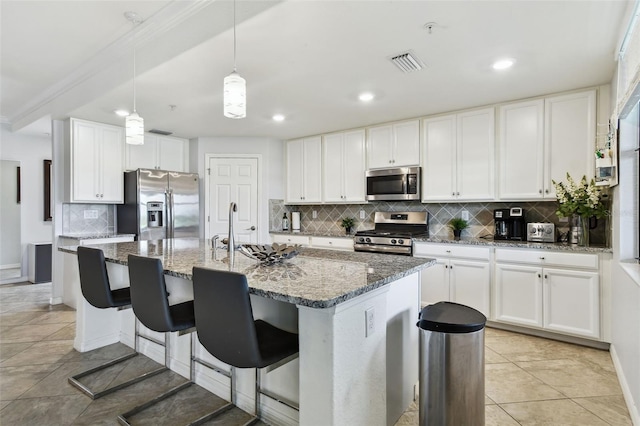 5916 Wake Forest Run Unit 101, Bradenton, FL 34211 - kitchen featuring stainless steel appliances, backsplash, stone countertops, white cabinetry, and recessed lighting