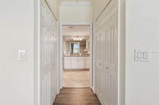5916 Wake Forest Run Unit 101, Bradenton, FL 34211 - corridor featuring ornamental molding and wood finished floors
