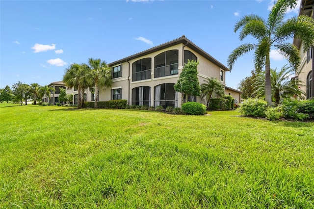 5916 Wake Forest Run Unit 101, Bradenton, FL 34211 - rear view of property with stucco siding and a lawn