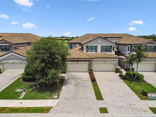 5916 Wake Forest Run Unit 101, Bradenton, FL 34211 - view of front of house with a tile roof, stucco siding, driveway, and a residential view