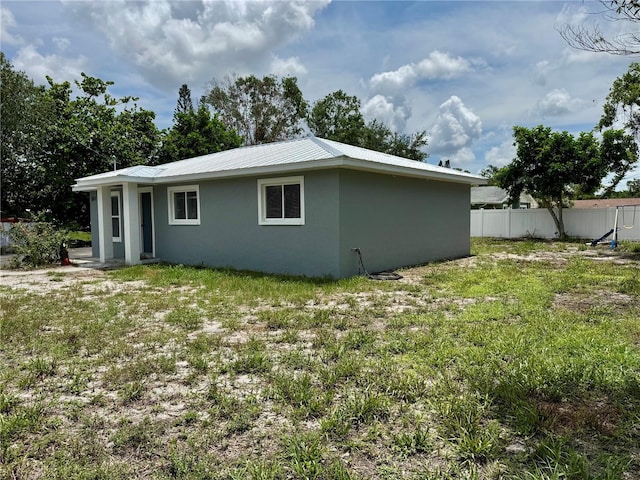 811 24th Street Ct E, Bradenton, FL 34208 - view of home's exterior featuring stucco siding and a metal roof