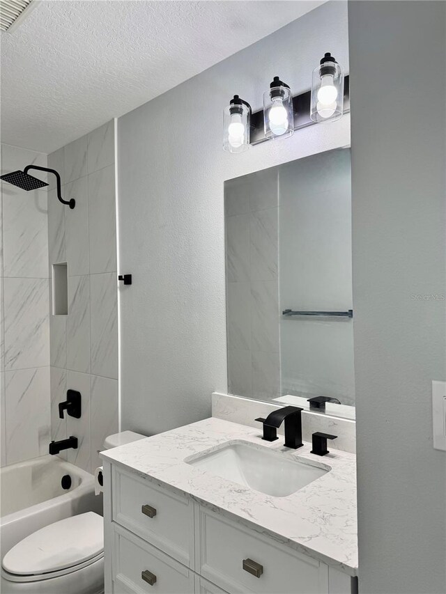 811 24th Street Ct E, Bradenton, FL 34208 - bathroom featuring vanity, tub / shower combination, and a textured ceiling