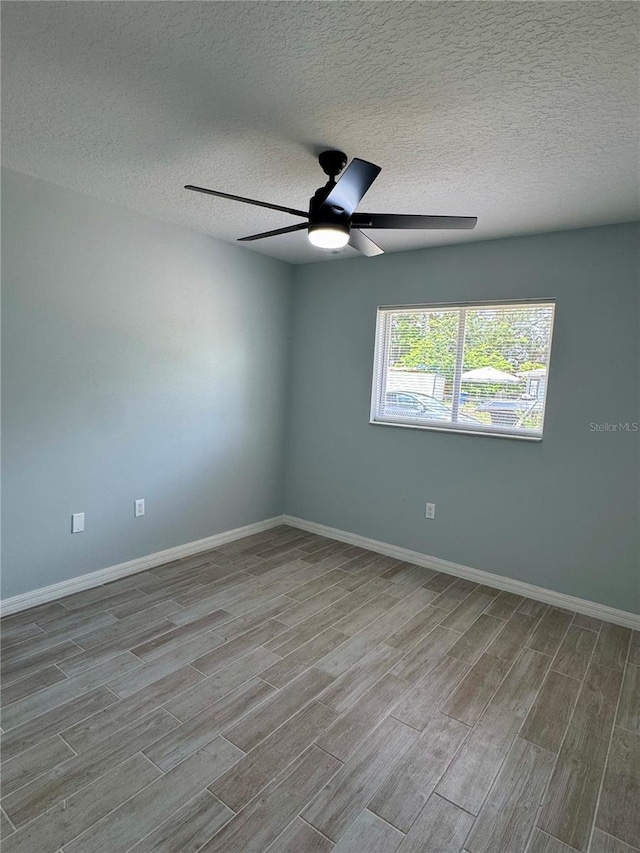 811 24th Street Ct E, Bradenton, FL 34208 - unfurnished room featuring wood finished floors, a textured ceiling, and ceiling fan