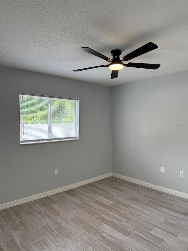 811 24th Street Ct E, Bradenton, FL 34208 - empty room featuring ceiling fan, wood tiled floors, and a textured ceiling
