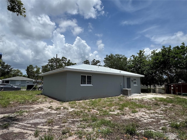811 24th Street Ct E, Bradenton, FL 34208 - view of side of property with a metal roof and stucco siding
