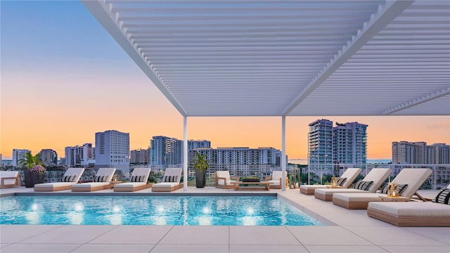 1305 4th St Unit 301G, Sarasota, FL 34236 - pool at dusk with a community pool, a city view, and a patio