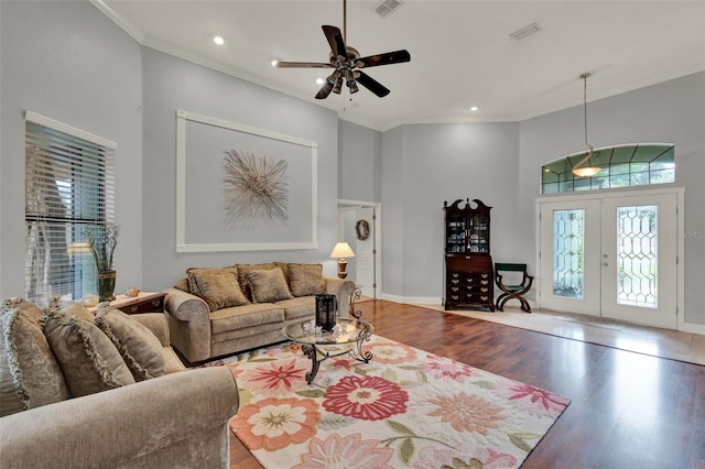 17426 Tailfeather Ct, Clermont, FL 34711 - living area with french doors, ceiling fan, wood finished floors, a towering ceiling, and ornamental molding