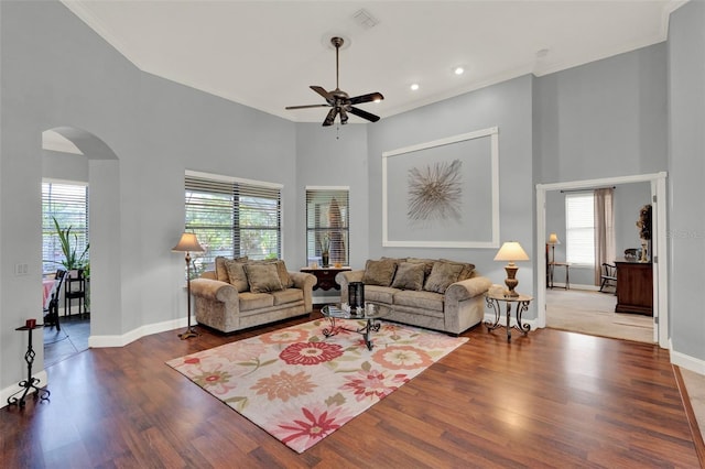 17426 Tailfeather Ct, Clermont, FL 34711 - living area featuring arched walkways, plenty of natural light, ceiling fan, ornamental molding, and wood finished floors