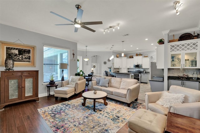 17426 Tailfeather Ct, Clermont, FL 34711 - living area with crown molding, ceiling fan, wood finished floors, and arched walkways