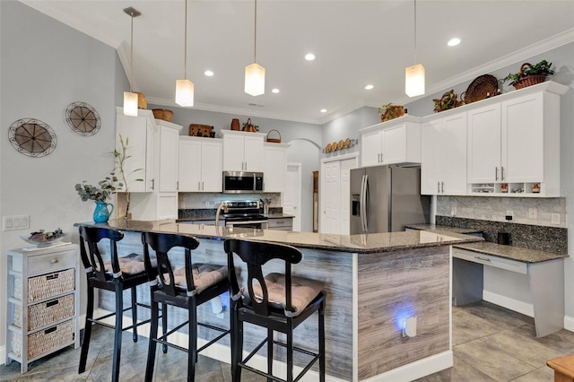 17426 Tailfeather Ct, Clermont, FL 34711 - kitchen with appliances with stainless steel finishes, a peninsula, decorative backsplash, crown molding, and dark stone countertops