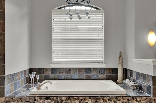 17426 Tailfeather Ct, Clermont, FL 34711 - bathroom featuring a bath, healthy amount of natural light, and a chandelier