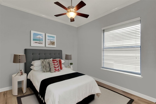 17426 Tailfeather Ct, Clermont, FL 34711 - bedroom featuring crown molding, light wood-type flooring, multiple windows, and ceiling fan
