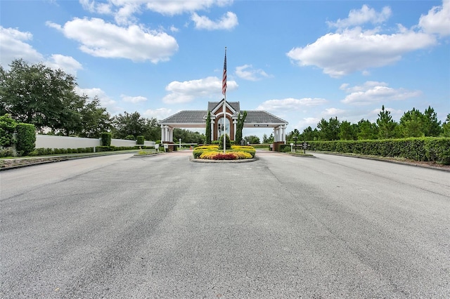 17426 Tailfeather Ct, Clermont, FL 34711 - view of asphalt road featuring a gated entry and curbs