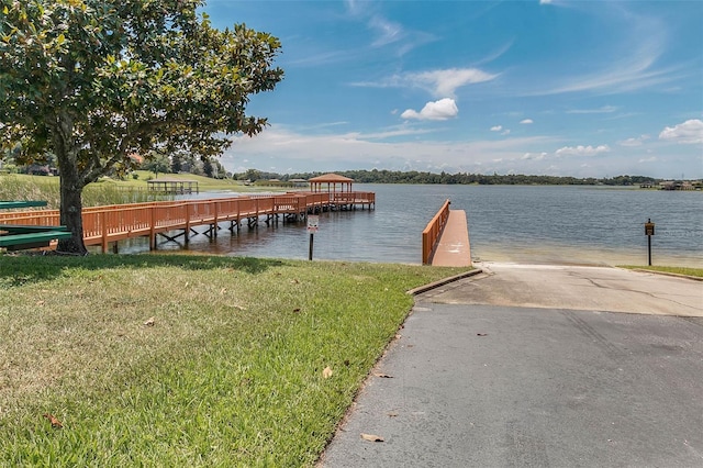 17426 Tailfeather Ct, Clermont, FL 34711 - dock area featuring a boat ramp, a lawn, and a water view
