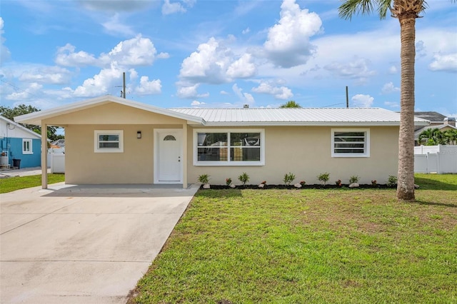 609 Carmel Rd, Venice, FL 34293 - ranch-style house with stucco siding, a metal roof, and driveway