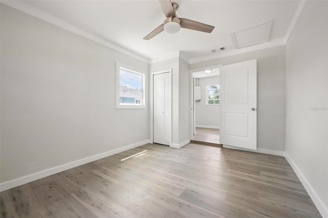 609 Carmel Rd, Venice, FL 34293 - unfurnished bedroom with ornamental molding, light wood-style flooring, a closet, ceiling fan, and attic access