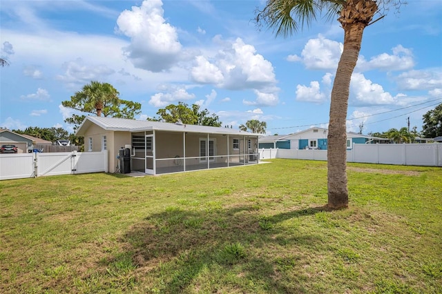 609 Carmel Rd, Venice, FL 34293 - rear view of house with a gate, a sunroom, a fenced backyard, and a metal roof