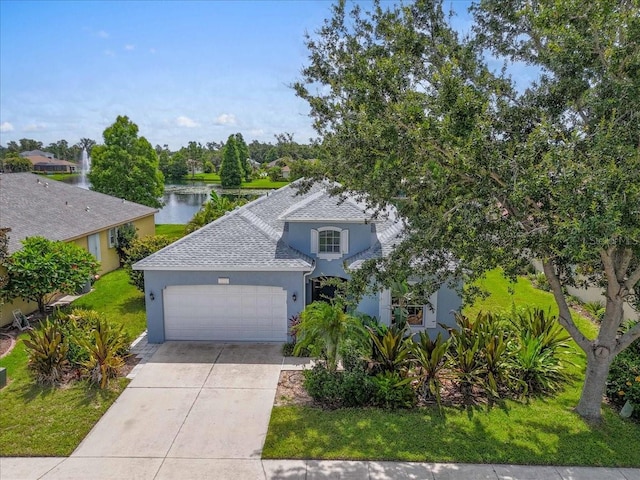 7026 43rd Ave E, Palmetto, FL 34221 - view of front of property featuring stucco siding, a garage, a water view, concrete driveway, and roof with shingles