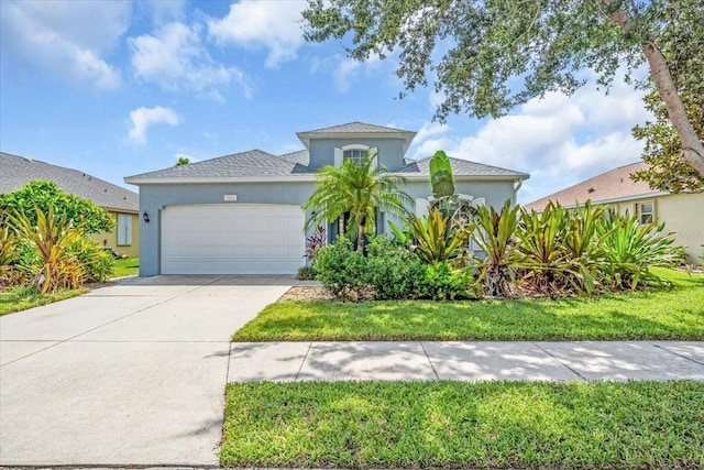 7026 43rd Ave E, Palmetto, FL 34221 - mediterranean / spanish-style house with stucco siding, a garage, and concrete driveway