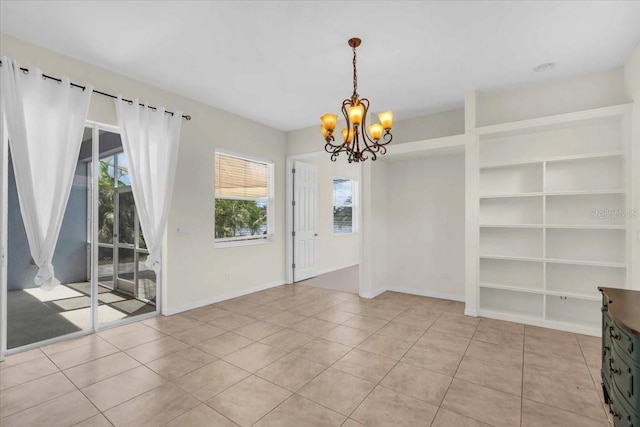 7026 43rd Ave E, Palmetto, FL 34221 - unfurnished dining area with a chandelier, built in features, and light tile patterned floors