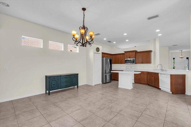 7026 43rd Ave E, Palmetto, FL 34221 - kitchen with stainless steel appliances, light countertops, a chandelier, light tile patterned floors, and recessed lighting