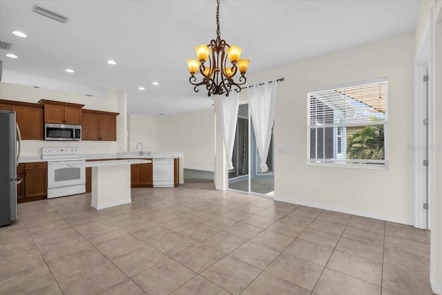 7026 43rd Ave E, Palmetto, FL 34221 - kitchen with stainless steel appliances, open floor plan, a kitchen island, a chandelier, and light countertops