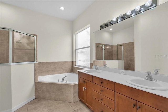 7026 43rd Ave E, Palmetto, FL 34221 - bathroom featuring a garden tub, double vanity, tiled shower, and tile patterned flooring