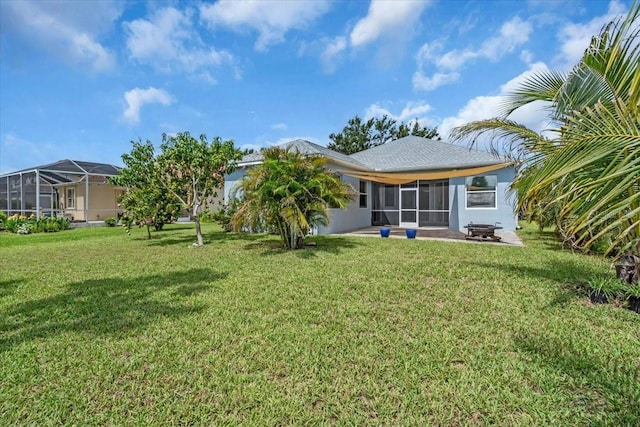 7026 43rd Ave E, Palmetto, FL 34221 - back of property with a lawn, a sunroom, and a patio