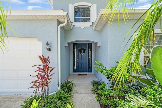 7026 43rd Ave E, Palmetto, FL 34221 - property entrance with a garage and stucco siding