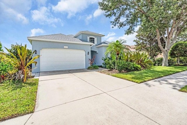 7026 43rd Ave E, Palmetto, FL 34221 - mediterranean / spanish-style house with an attached garage, driveway, stucco siding, and a front yard