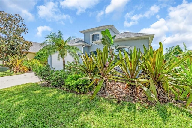 7026 43rd Ave E, Palmetto, FL 34221 - view of front of home featuring concrete driveway, stucco siding, a garage, and a front lawn