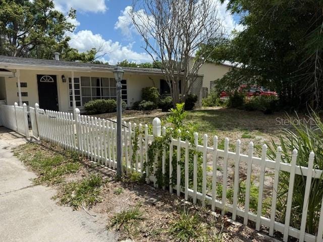 2451 Loma Linda St, Sarasota, FL 34239 - ranch-style home with a fenced front yard and stucco siding