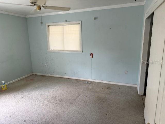 2451 Loma Linda St, Sarasota, FL 34239 - empty room featuring crown molding, a ceiling fan, and carpet