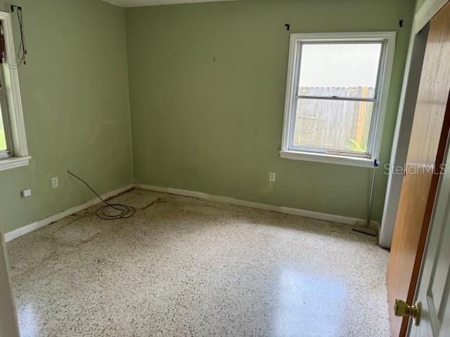 2451 Loma Linda St, Sarasota, FL 34239 - unfurnished room with speckled floor and baseboards